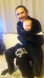 Ziiggy and AJ wrapped in a blanket.