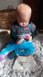 Ziggy studying a menstrual cup intently.