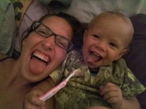 Me and Ziggy lying in bed sticking out our tongues.