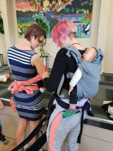 Babywearing, while helping other parents to babywear.